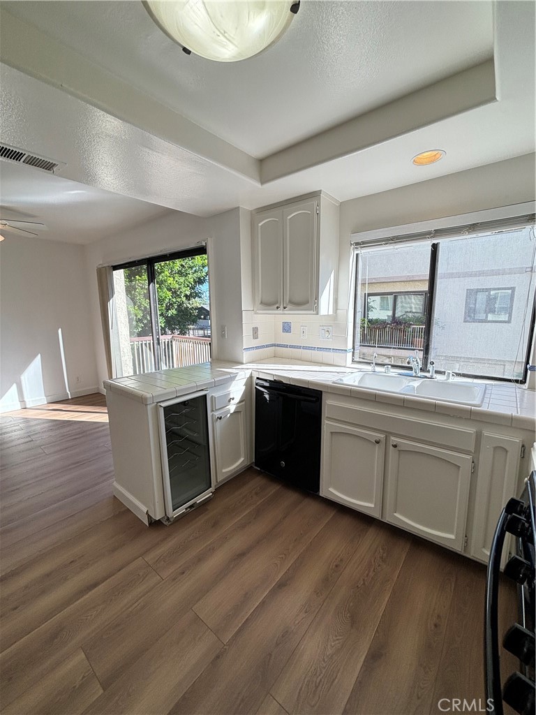 7100 Balboa Boulevard, Unit 902 Van Nuys, CA 91406 - Photo 11 of 29 a kitchen with a sink cabinets and wooden floor