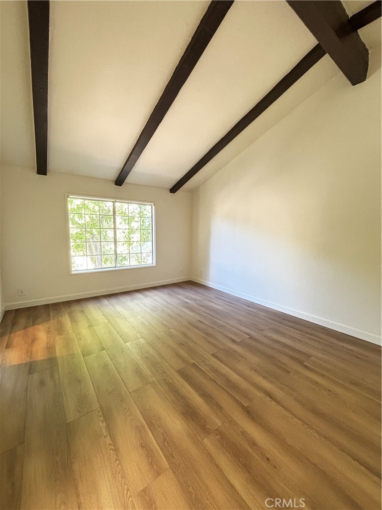 7100 Balboa Boulevard, Unit 902 Van Nuys, CA 91406 - Photo 16 of 29 a view of an empty room with wooden floor and a window