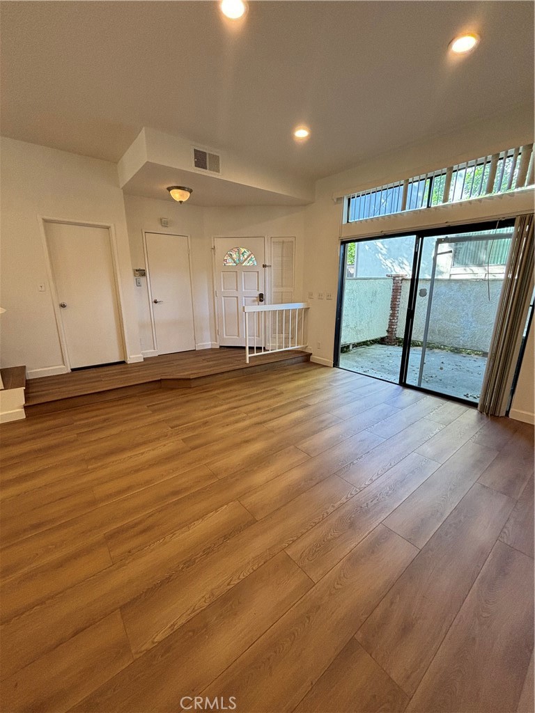7100 Balboa Boulevard, Unit 902 Van Nuys, CA 91406 - Photo 3 of 29 a view of an empty room with window and wooden floor