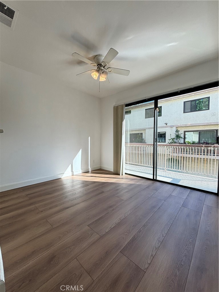 7100 Balboa Boulevard, Unit 902 Van Nuys, CA 91406 - Photo 8 of 29 a view of an empty room with a window and wooden floor
