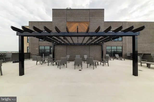 a view of a patio with table and chairs