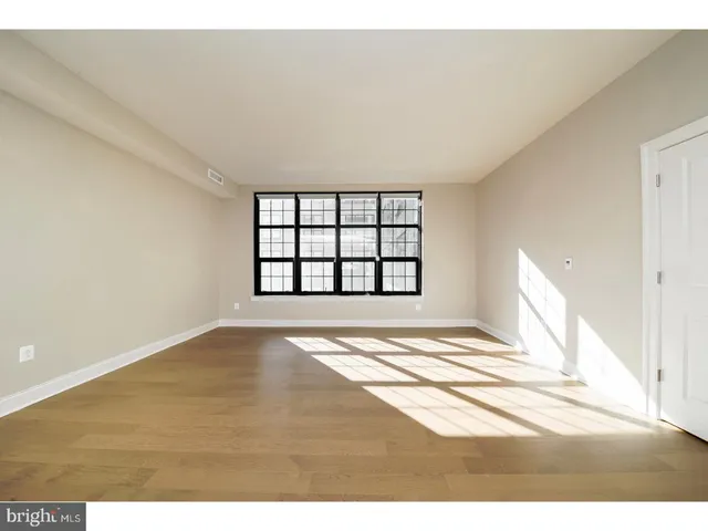 a view of empty room with a fireplace