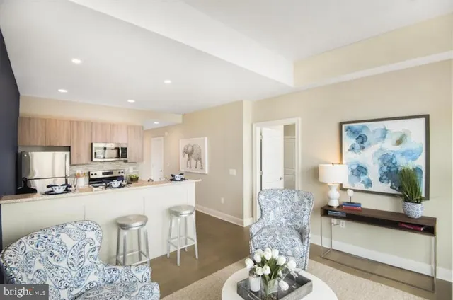 a living room with furniture and kitchen view