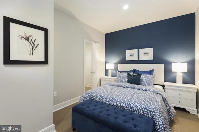 a bedroom with a bed and a night stand