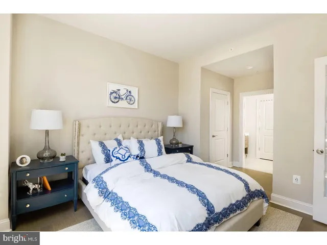 a bedroom with a bed and a night stand