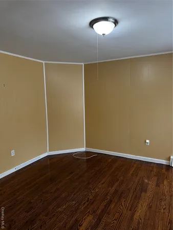 a view of room with hardwood floor and window