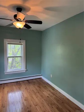 a view of an empty room and wooden floor