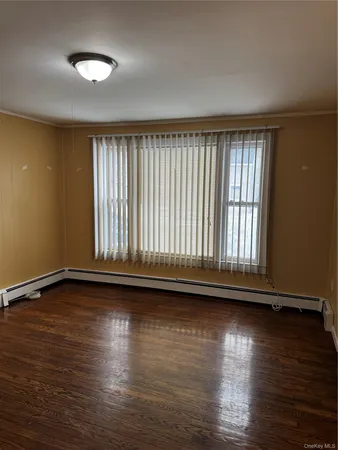a view of room with hardwood floor and window