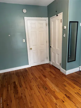 a view of a room with wooden floor and window