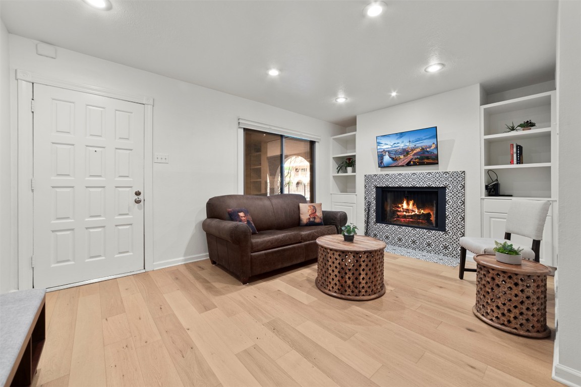 505 West 7th Street, Unit 113 Austin, TX 78701 - Photo 1 of 26 a living room with furniture and a fireplace