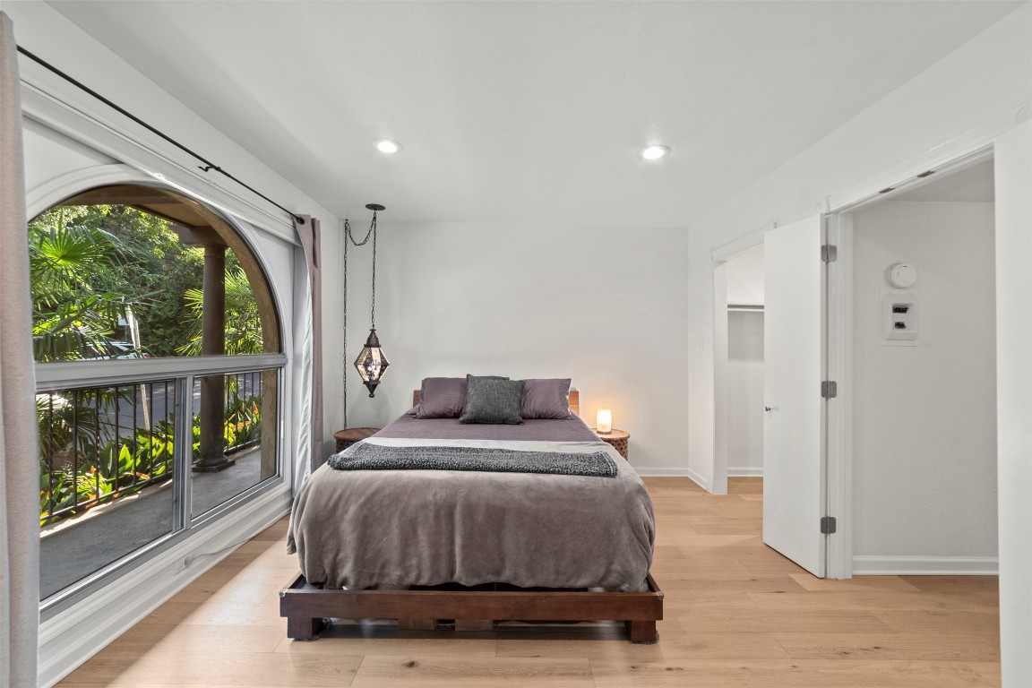 505 West 7th Street, Unit 113 Austin, TX 78701 - Photo 15 of 26 a bedroom with a bed and a large window