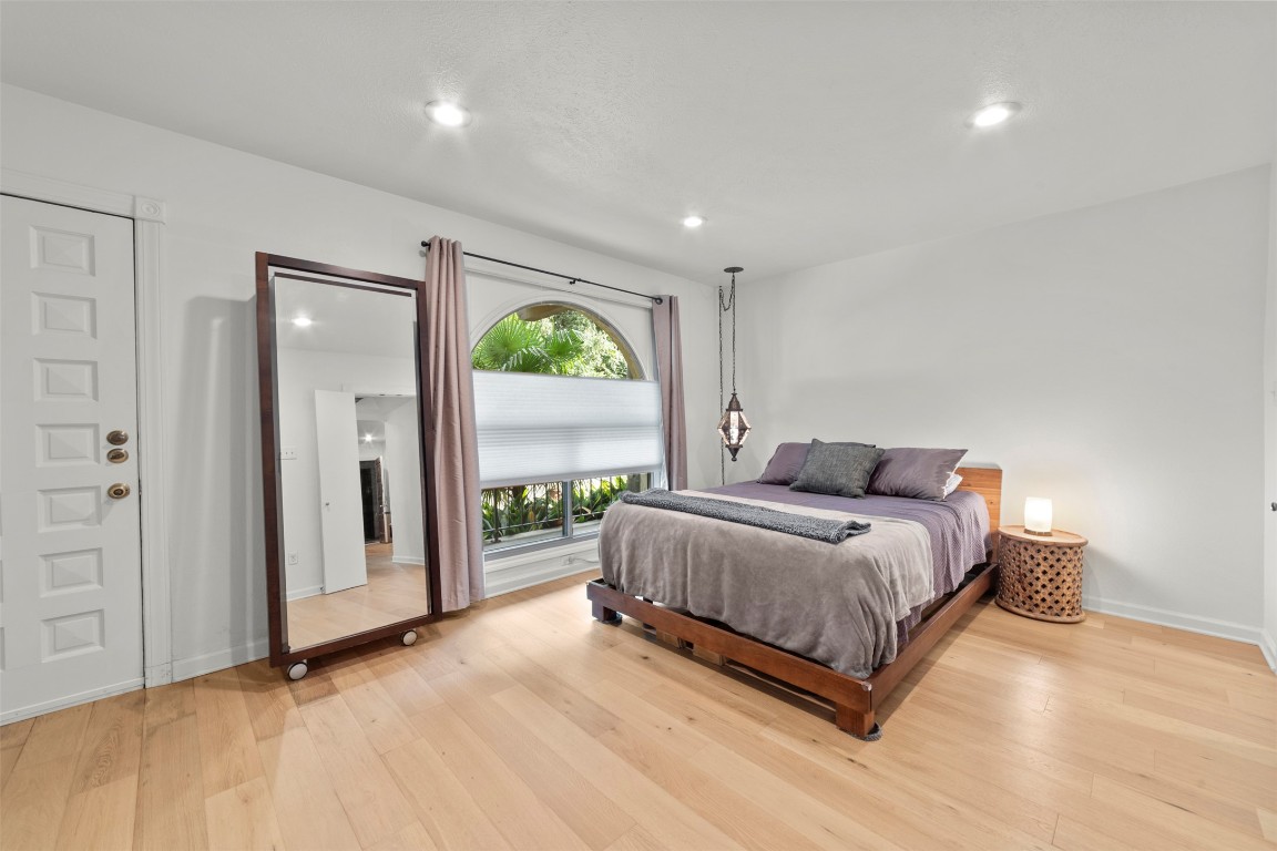 505 West 7th Street, Unit 113 Austin, TX 78701 - Photo 17 of 26 a spacious bedroom with a bed and a large window
