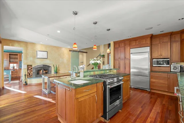 a kitchen with stainless steel appliances granite countertop a stove and a refrigerator