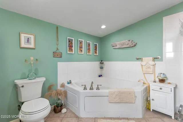 a white bath tub sitting next to a white toilet