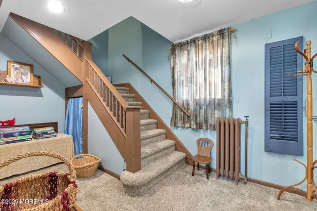 a view of hallway with stairs and furniture