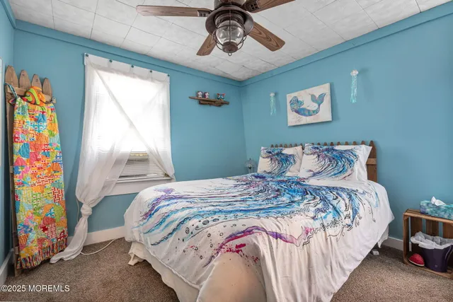 a bedroom with bed and a window