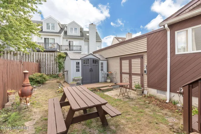 a view of a house with backyard and sitting area