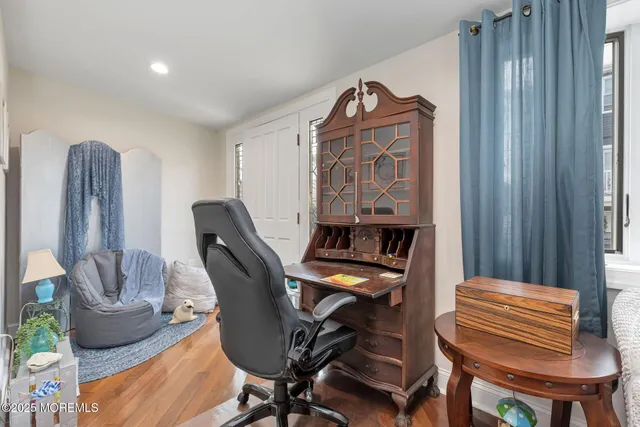 a view of a workspace with furniture and a window