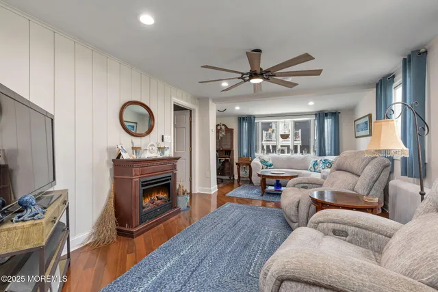 a living room with furniture a fireplace and a flat screen tv