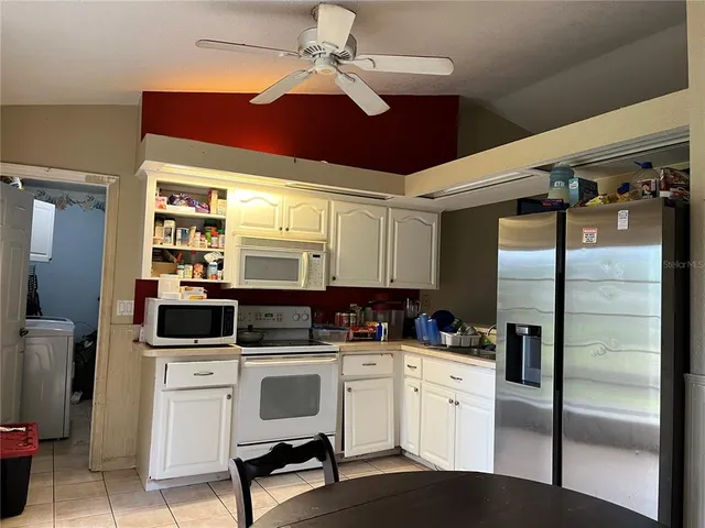 a kitchen with stainless steel appliances a refrigerator sink and cabinets