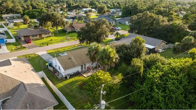 an aerial view of a houses with yard