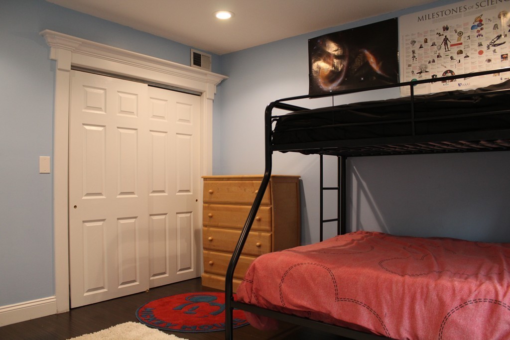 10 Shadowbrook Lane, Unit 19 Milford, MA 01757 - Photo 11 of 22 a bedroom with a bed and wooden floor