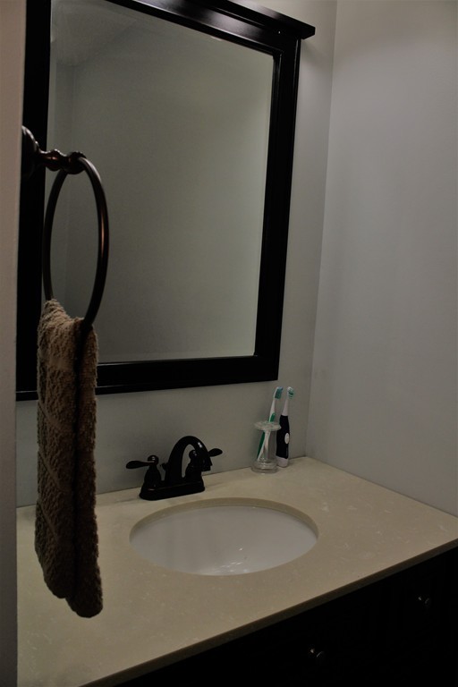 10 Shadowbrook Lane, Unit 19 Milford, MA 01757 - Photo 17 of 22 a bathroom with a sink and a mirror