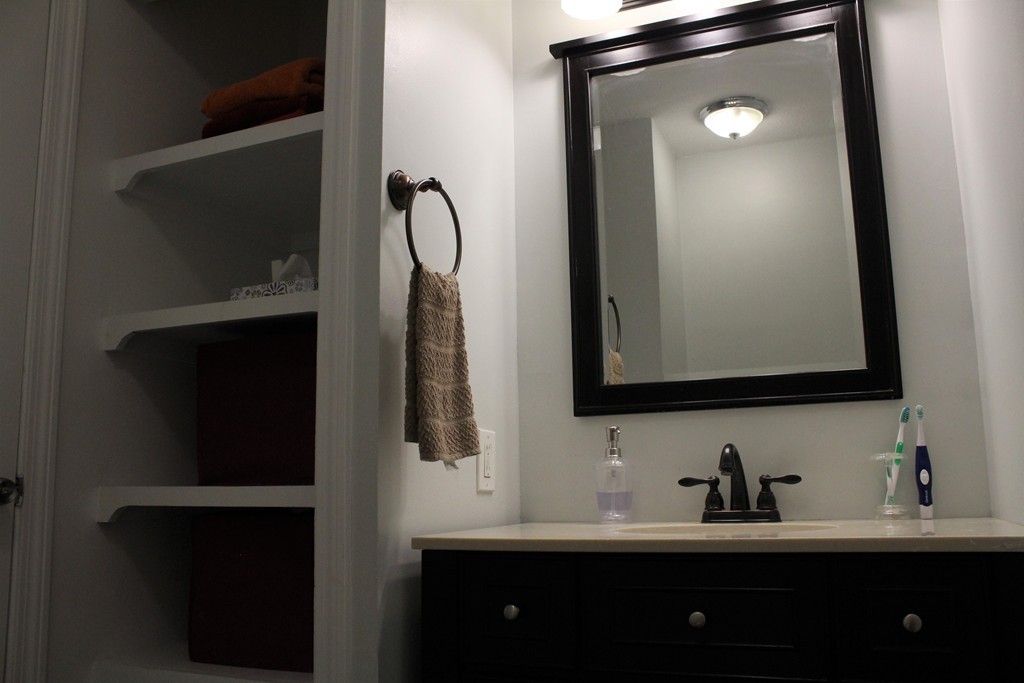 10 Shadowbrook Lane, Unit 19 Milford, MA 01757 - Photo 18 of 22 a bathroom with a sink and a mirror