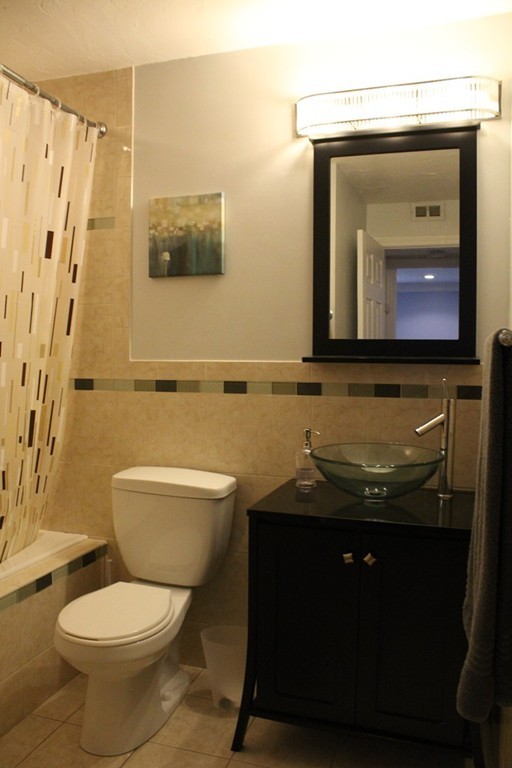 10 Shadowbrook Lane, Unit 19 Milford, MA 01757 - Photo 20 of 22 a bathroom with a granite countertop toilet sink and mirror