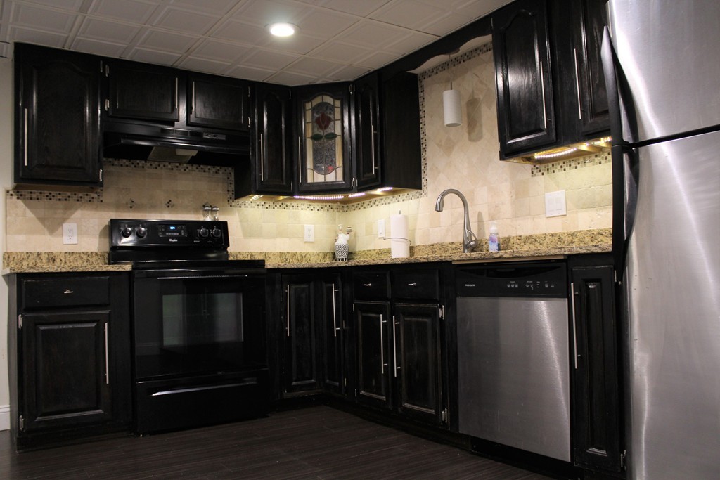 10 Shadowbrook Lane, Unit 19 Milford, MA 01757 - Photo 7 of 22 a kitchen with granite countertop stainless steel appliances and wooden cabinets