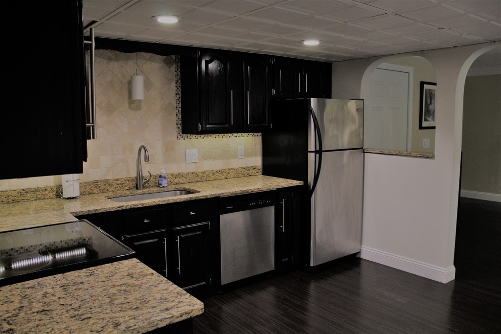 10 Shadowbrook Lane, Unit 19 Milford, MA 01757 - Photo 8 of 22 a kitchen with stainless steel appliances granite countertop a refrigerator a sink and a stove with wooden floor