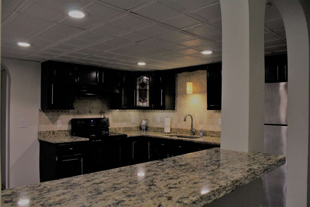 10 Shadowbrook Lane, Unit 19 Milford, MA 01757 - Photo 9 of 22 a kitchen with a sink and a refrigerator