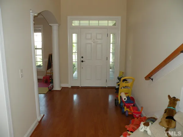 a view of kids room with wooden floor and stairs