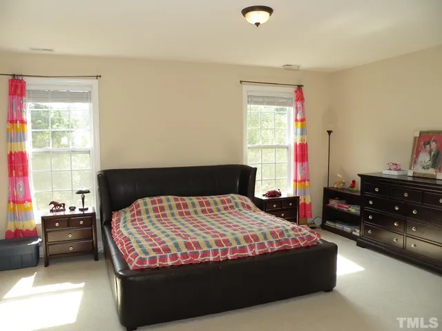 a bedroom with a bed and window