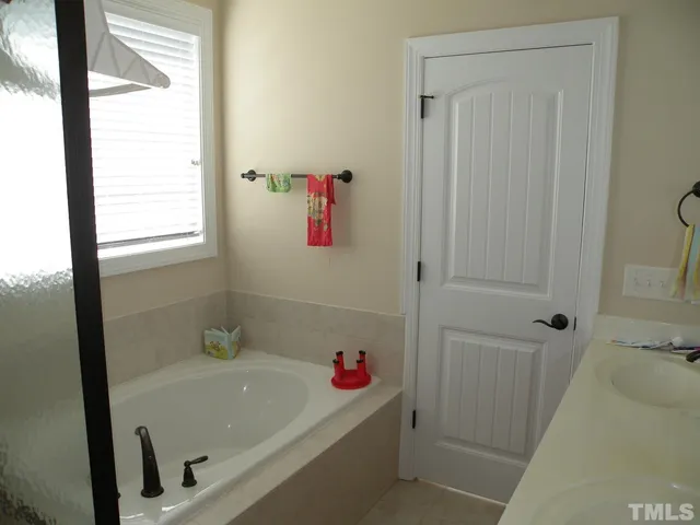 a bathroom with a bathtub and a shower