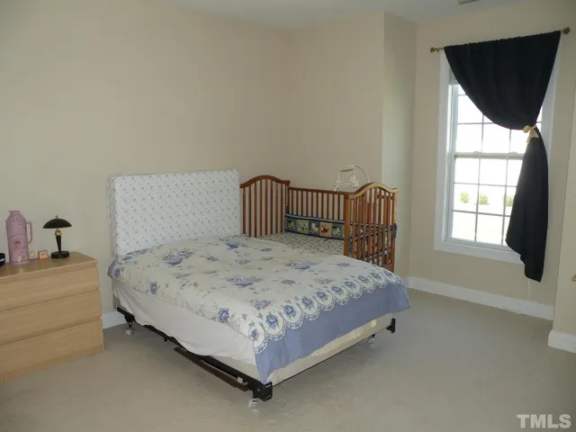 a bedroom with a bed and window