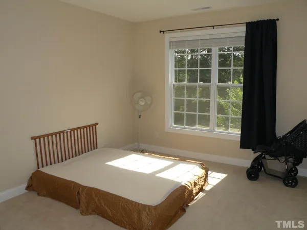 a bedroom with bed and a window