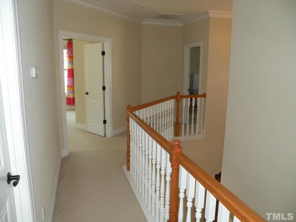 a view of staircase with railing and white walls