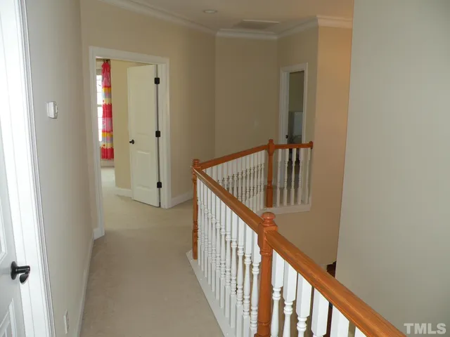 a view of staircase with railing and white walls