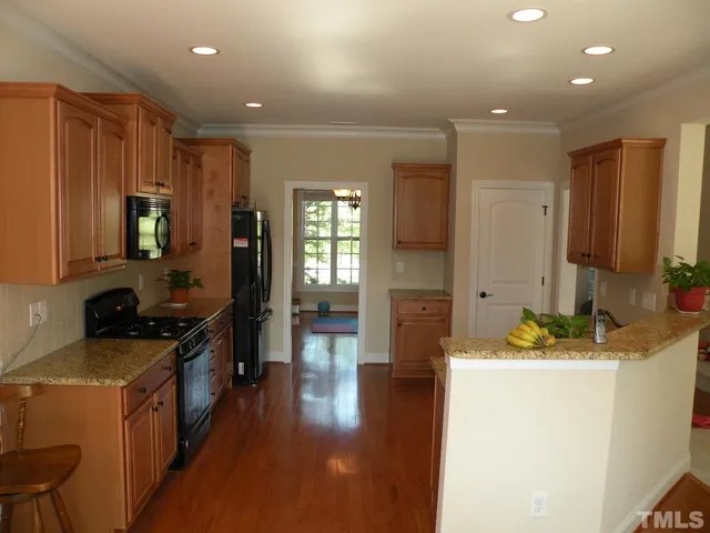 a kitchen with sink a refrigerator and cabinets