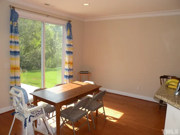 a view of a room with a table and chairs