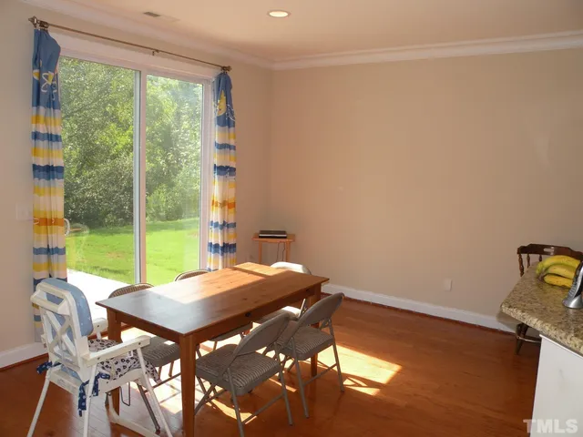 a view of a room with a table and chairs
