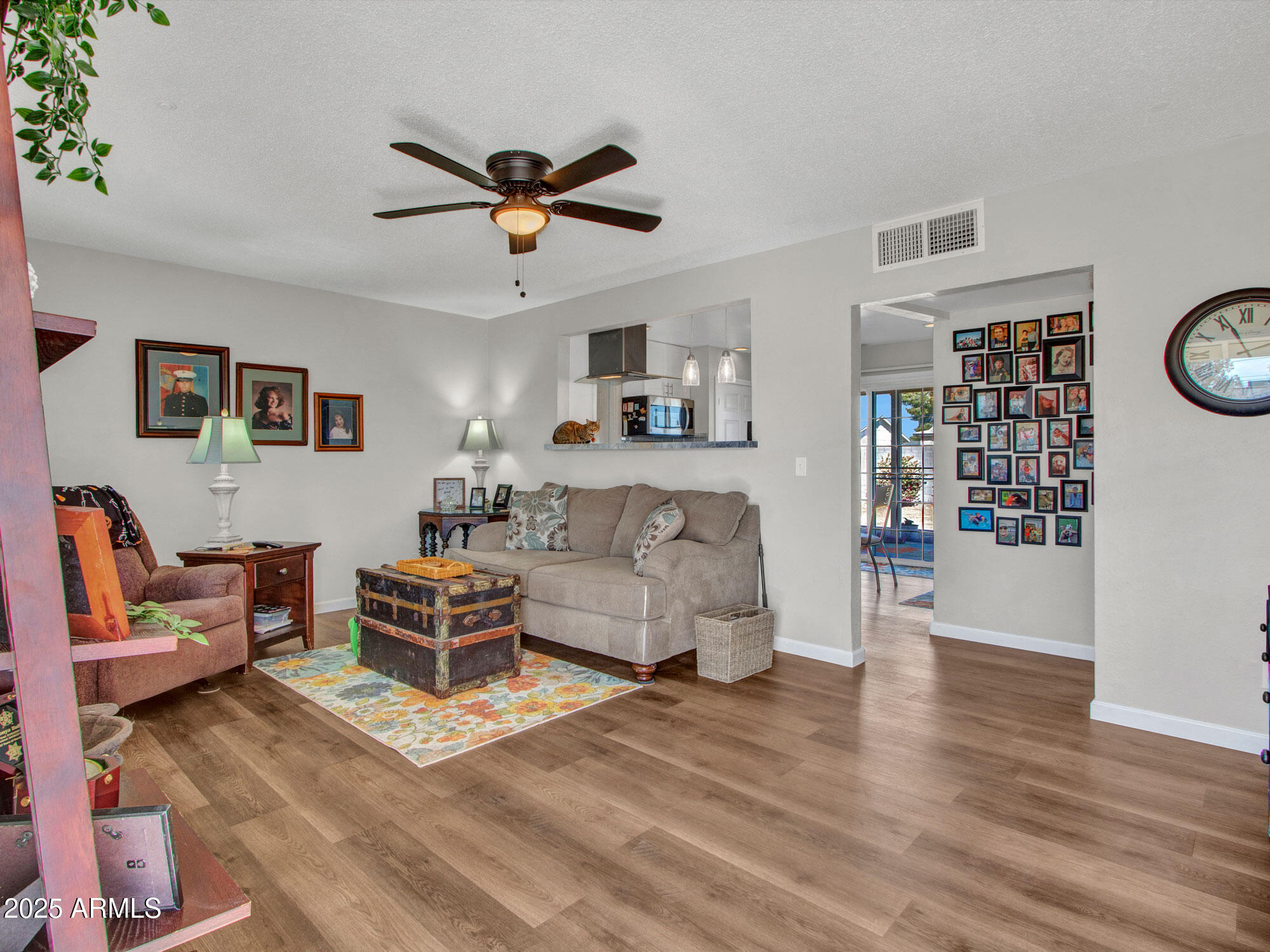 3328 West Charter Oak Road Phoenix, AZ 85029 - Photo 15 of 39 a living room with furniture and a wooden floor