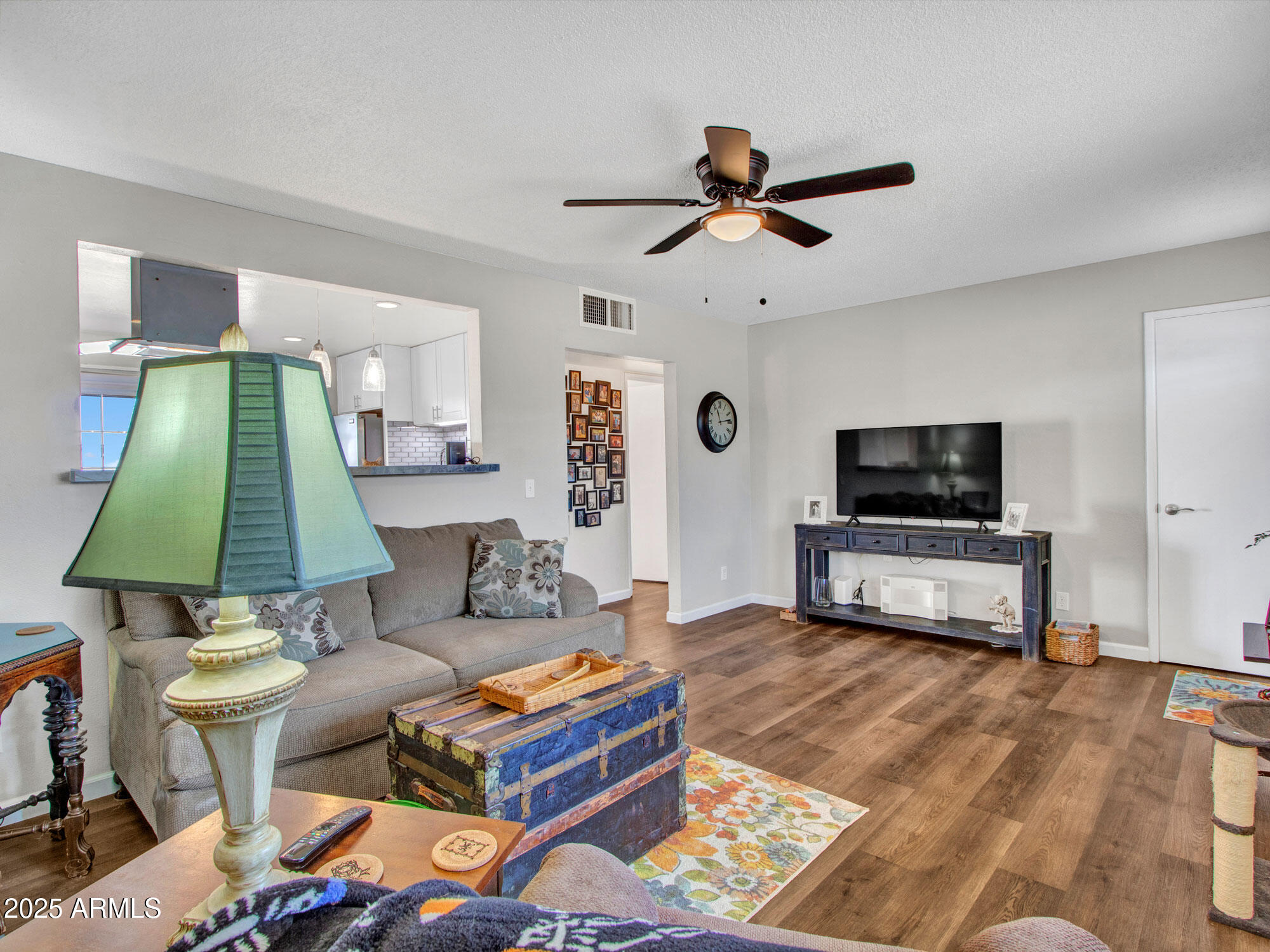 3328 West Charter Oak Road Phoenix, AZ 85029 - Photo 16 of 39 a living room with furniture and a flat screen tv