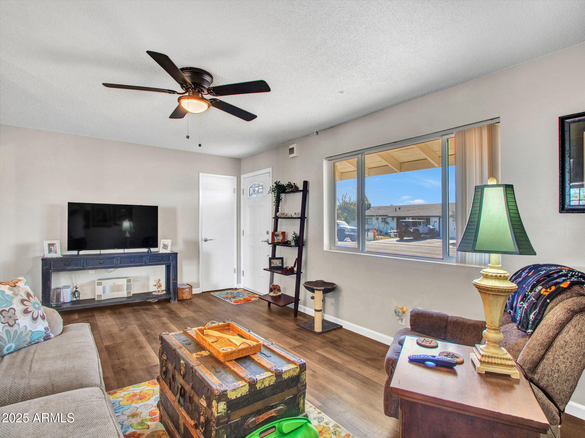3328 West Charter Oak Road Phoenix, AZ 85029 - Photo 17 of 39 a living room with furniture a flat screen tv and a window