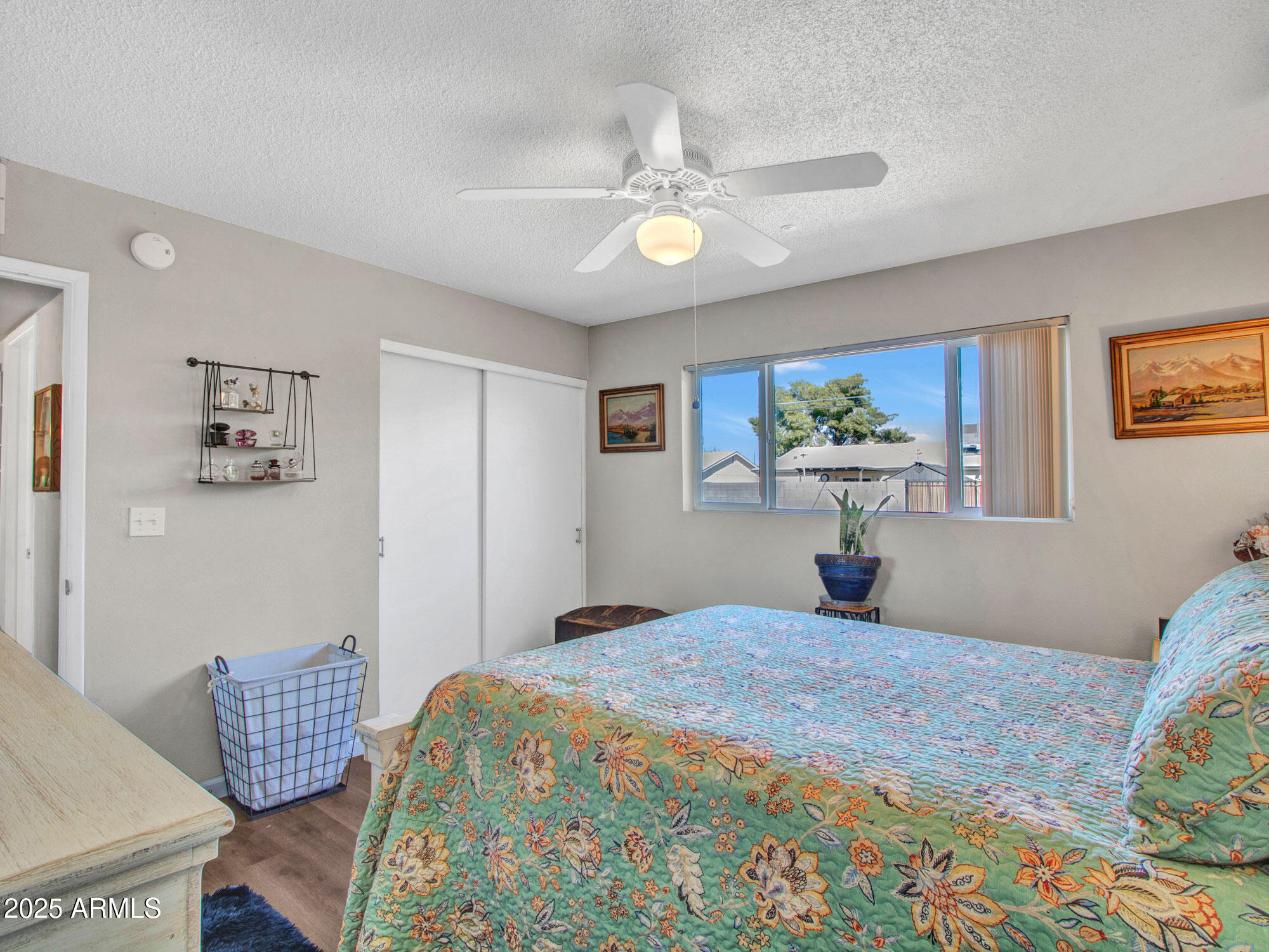 3328 West Charter Oak Road Phoenix, AZ 85029 - Photo 31 of 39 a bedroom with a bed and wooden floor