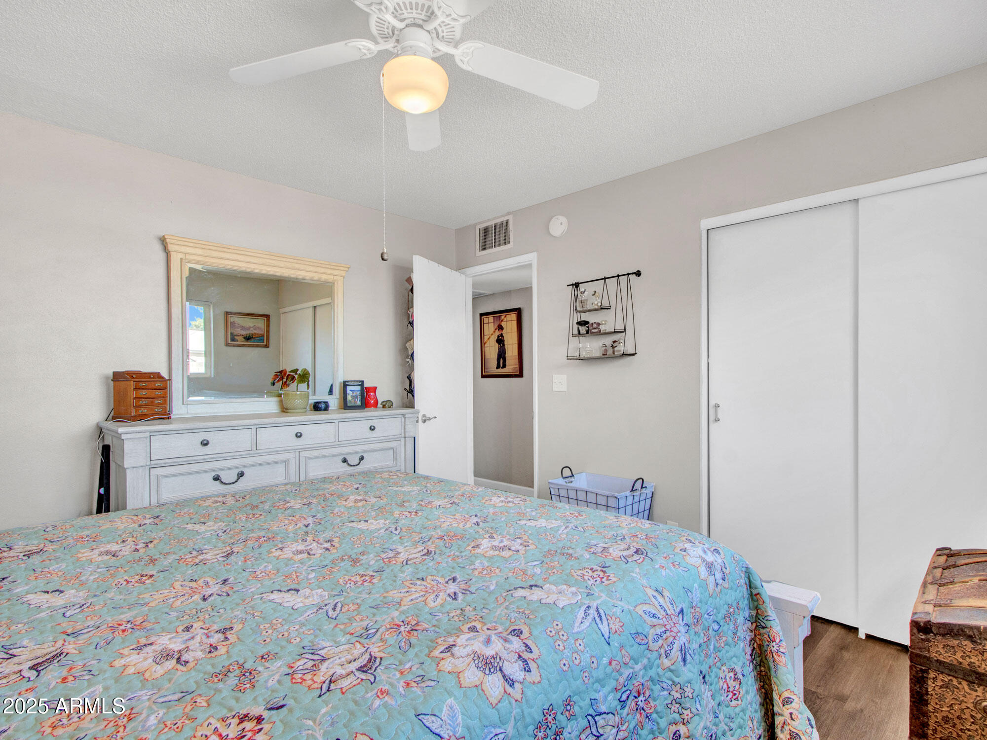 3328 West Charter Oak Road Phoenix, AZ 85029 - Photo 32 of 39 a bedroom with a large bed and a chandelier