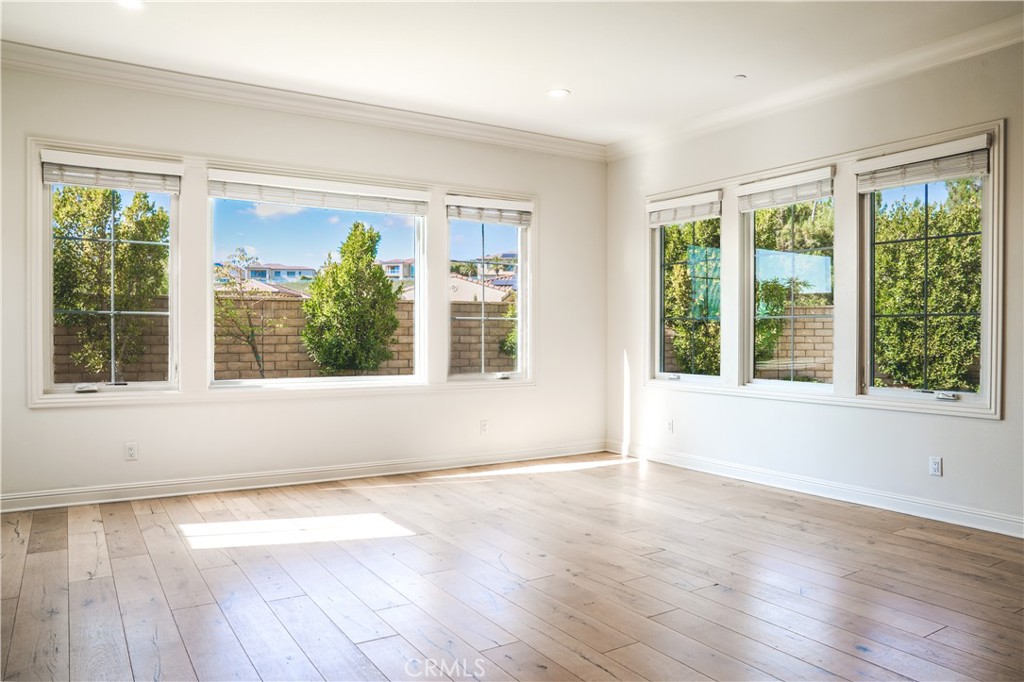 111 Lanzon Irvine, CA 92602 - Photo 13 of 42 a view of an empty room with wooden floor and a window