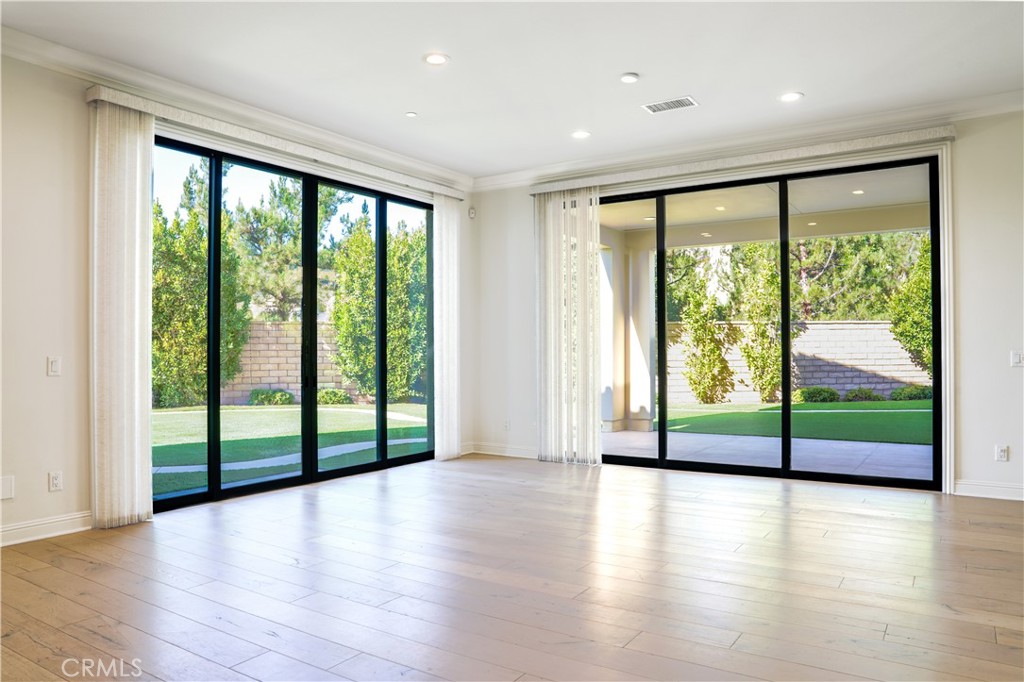 111 Lanzon Irvine, CA 92602 - Photo 14 of 42 a view of empty room with wooden floor and floor to ceiling window
