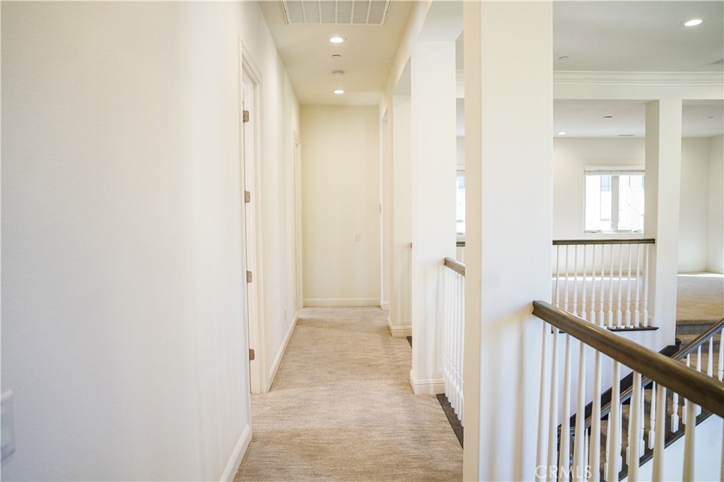 111 Lanzon Irvine, CA 92602 - Photo 17 of 42 a view of a hallway with a white walls and wooden floor